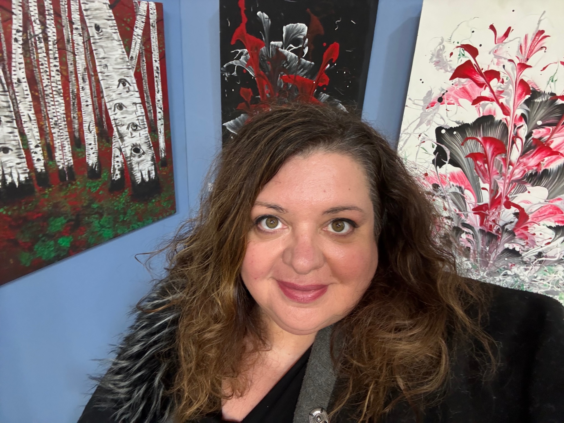 Kat Mustanow with exhibition artwork