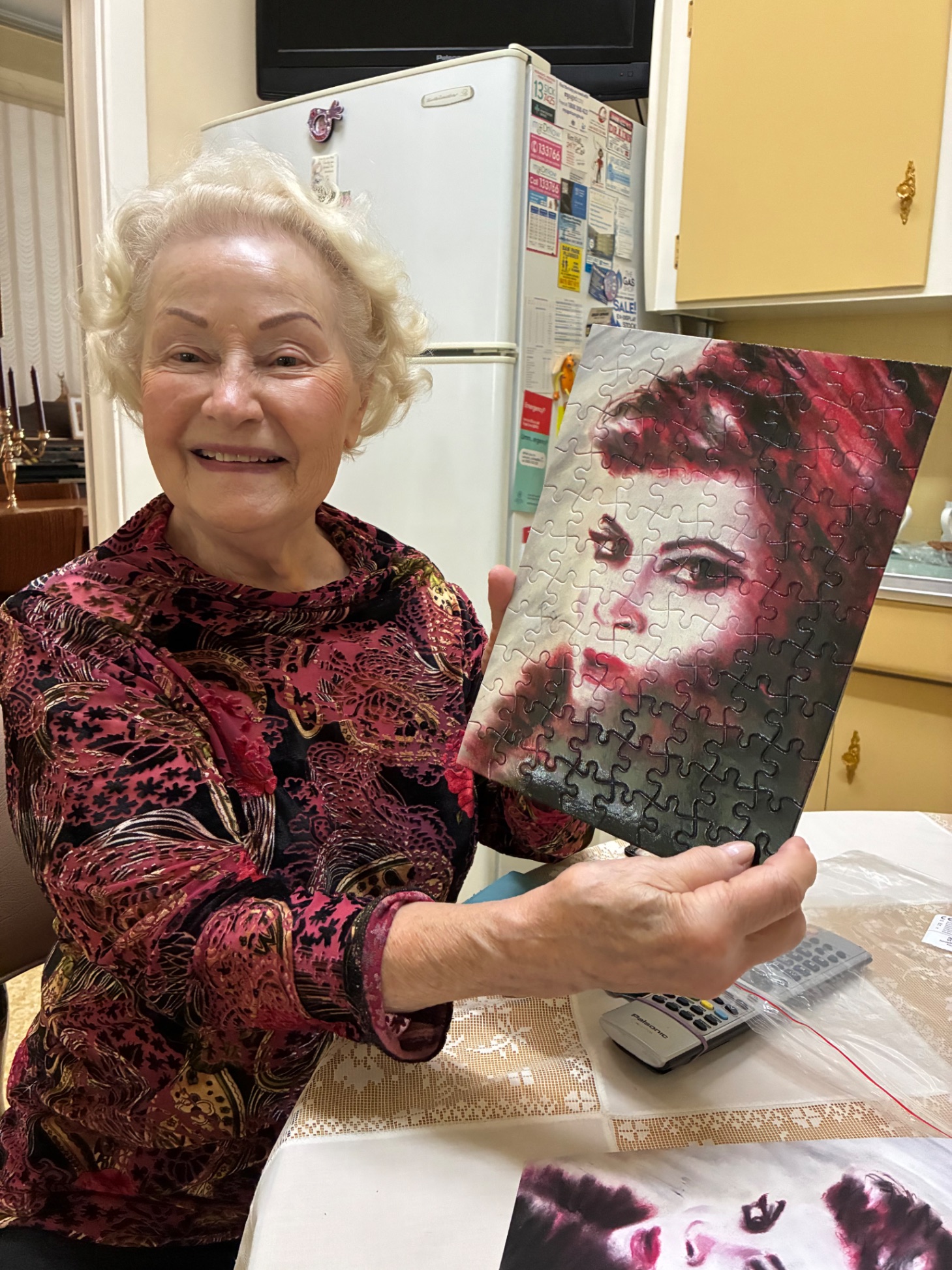 Happy customer holding a Kat Mustanow artwork jigsaw puzzle — a unique gift idea